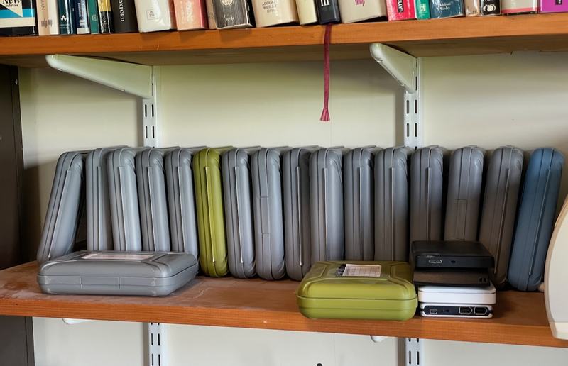 A shelf full of drives in protective cases